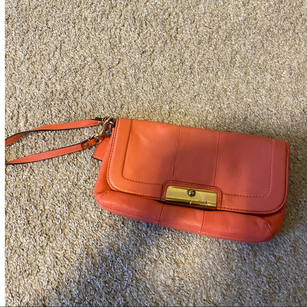 Coral and gold coach wristlet